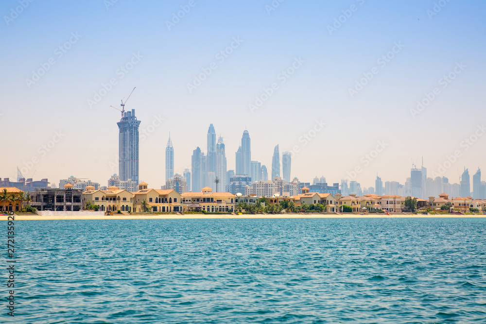 Dubai Marina skyscrapers and villas on the Palm Jumeirah. Luxury properties of UAE