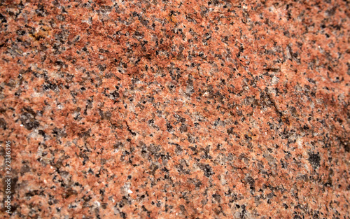 The texture of the red granite of different types. Background.