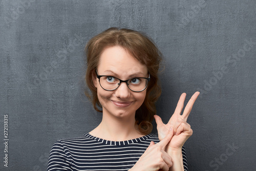 Portrait young woman making list of something with fingers