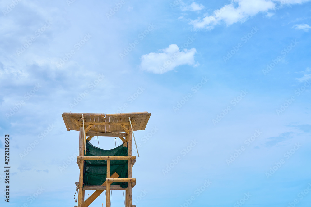Wooden lifeguard tower against a blue sky. Copy space. Wooden lifeguard tower against a blue sky. Copy space.