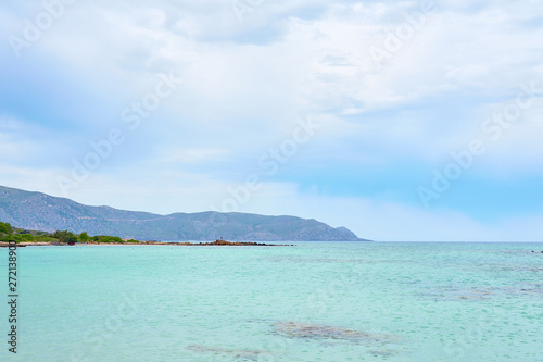  Turquoise clear sea water in tropical beach with cloudy sky on a background. Copy space.