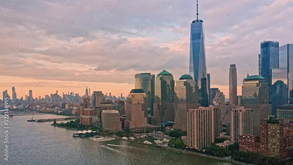 Slow drone rotation around Lower Manhattan skyline at sunset