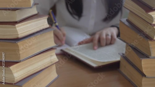 Young Woman Doing Homework In Library photo