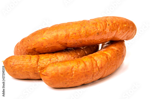 Sausage meat, non-GMO with glitter on a light background. A ring of juicy sausage in a natural casing on a white background.