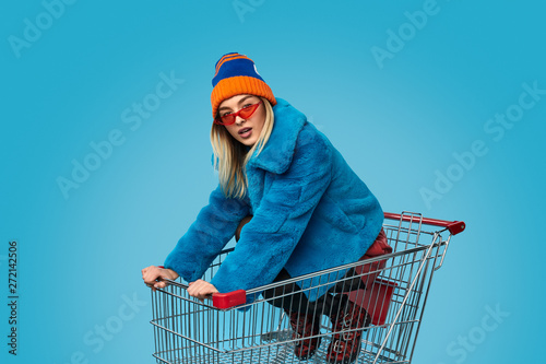 Crazy female in shopping cart photo