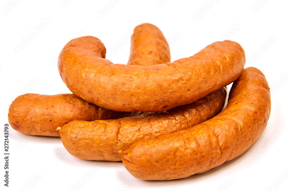 Sausages on a light background. Juicy sausage rings in a pile on a white background. Sausages on a light background. Juicy sausage rings in a pile on a white background.