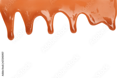 Delicious caramel sauce flowing on white background