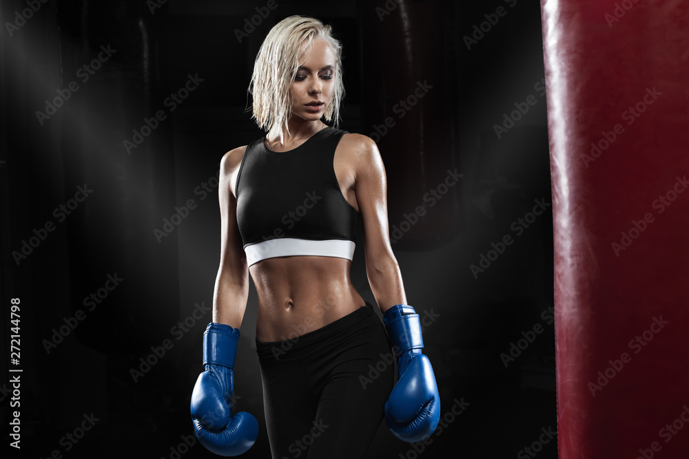 Female boxer training. Active woman posing in boxing gloves Stock Photo