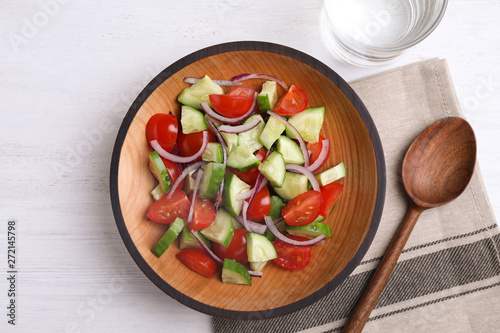 Flat lay composition with delicious fresh cucumber tomato salad served on table