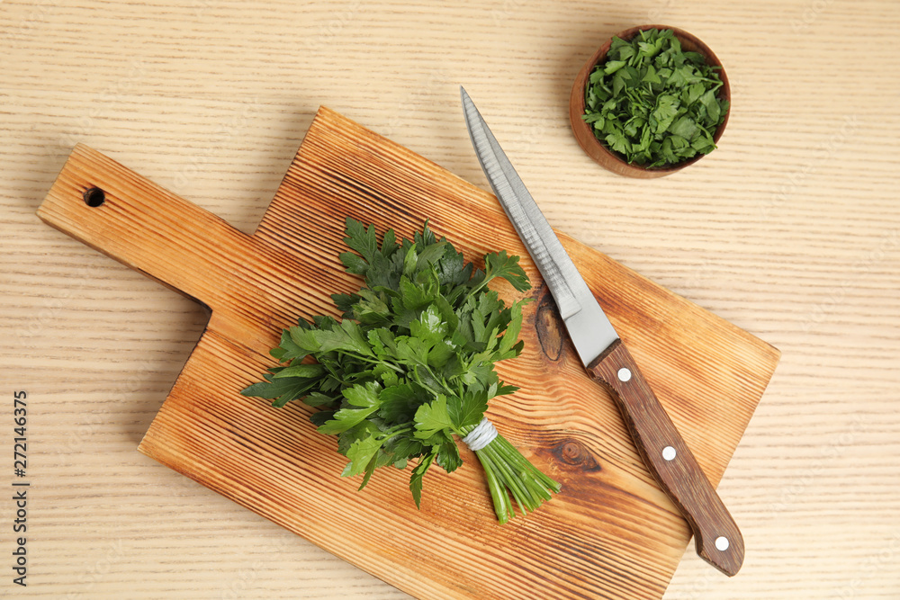 Flat lay composition with fresh green parsley on wooden background
