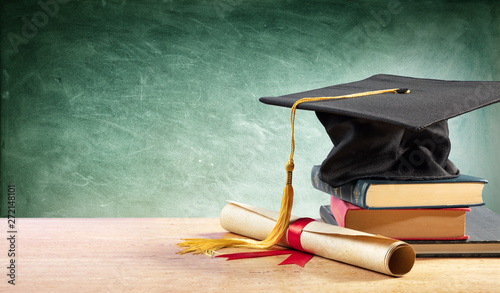Foto Graduation Cap And Diploma On Table With Books