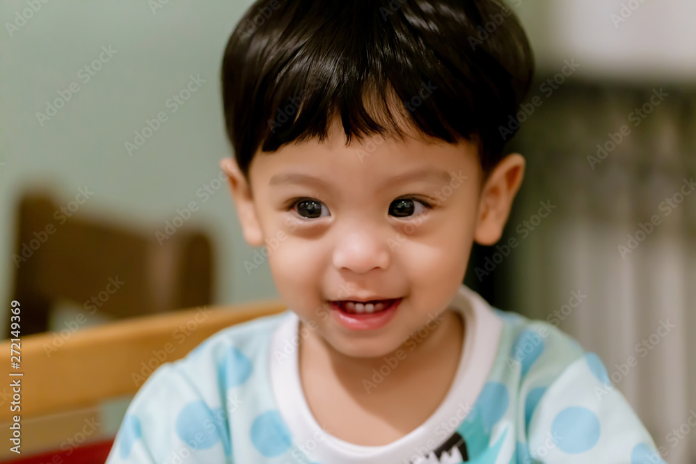 Portrait Of Happy Young Baby Boy In High Chair. Child sitting at empty table.Baby nutrition concept.Food advertisement design. smiling baby sitting on baby Chair. Portrait Of Happy Young Baby Boy In High Chair. Child sitting at empty table.Baby nutrition concept.Food advertisement design. smiling baby sitting on baby Chair.