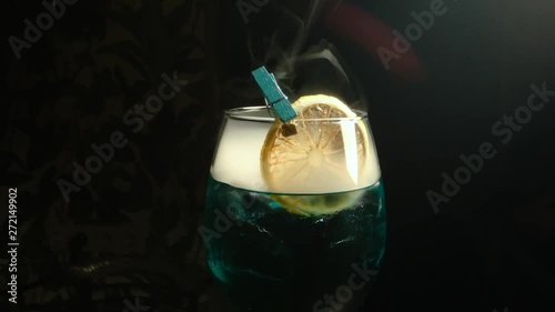 Alcoholic Drink With Lemon. Smoke. Close-up. photo