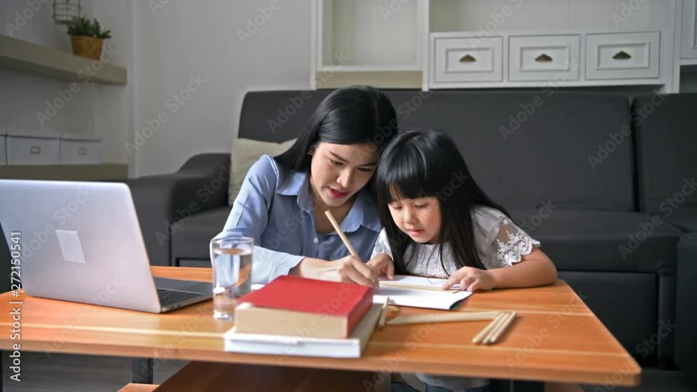 Family concept. Mother is teaching daughter to paint in the living room. Family concept. Mother is teaching daughter to paint in the living room.