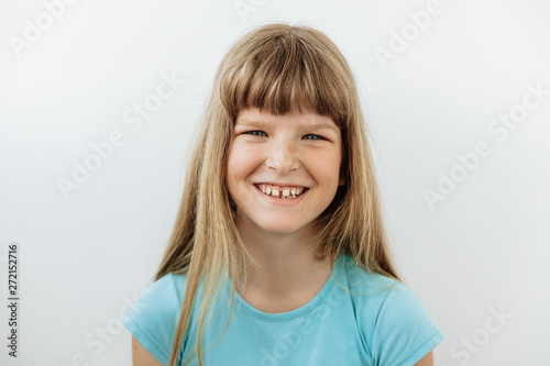 9 year girl portrait against white background. Laughter and joy emotions