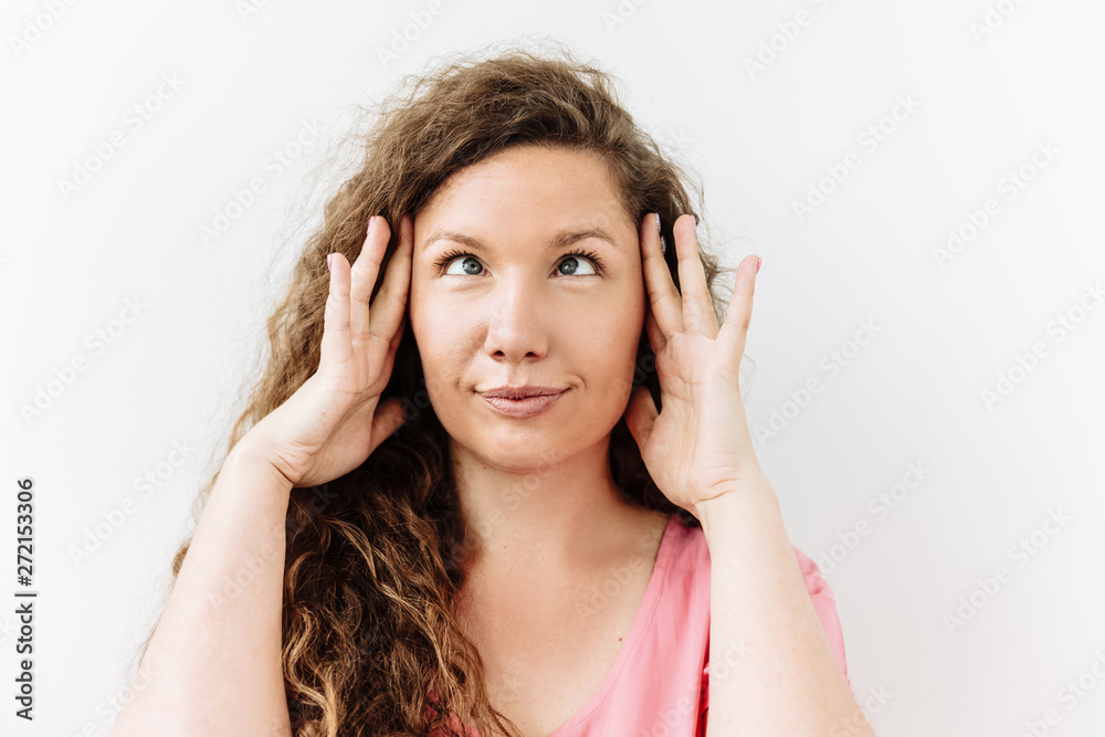 Making face, funny foolishes portrait of curly crossed eyes woman, against white background. Making face, funny foolishes portrait of curly crossed eyes woman, against white background.