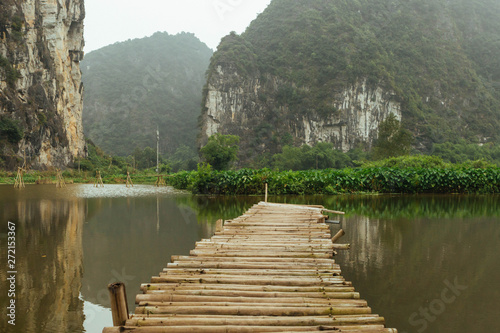 Mountain landscape with a wood bridge and lake, NinhBinh, vietnamese panorama in Trang An