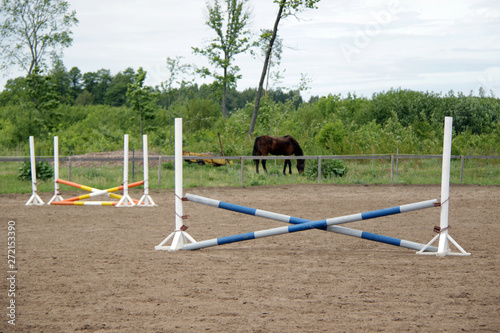 barriers for horse training and meadow on background