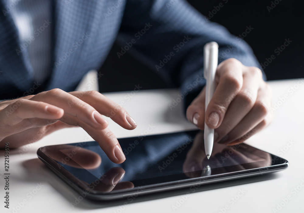 Man in business suit sitting at desk with tablet Man in business suit sitting at desk with tablet