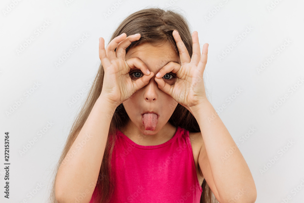Making face,funny foolishes portrait of 9 year girl ,against white background. Making face,funny foolishes portrait of 9 year girl ,against white background.