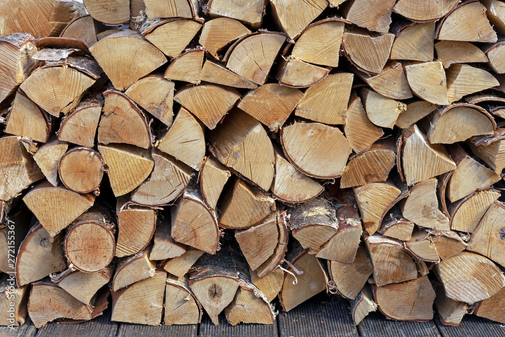 Stacked firewood for kindling a stove, fireplace, barbecue or bonfire. Firewood background. Wood texture. Stacked firewood for kindling a stove, fireplace, barbecue or bonfire. Firewood background. Wood texture.
