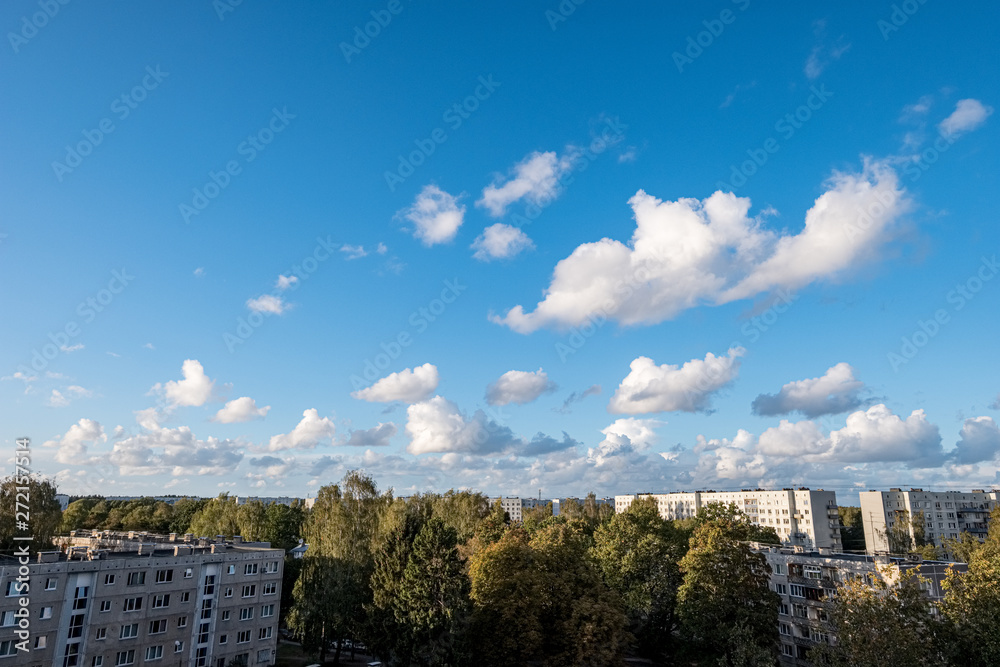 countryside landscape under blue sky and dramatic white clouds