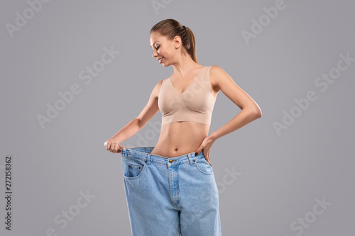 Glad female in oversized jeans