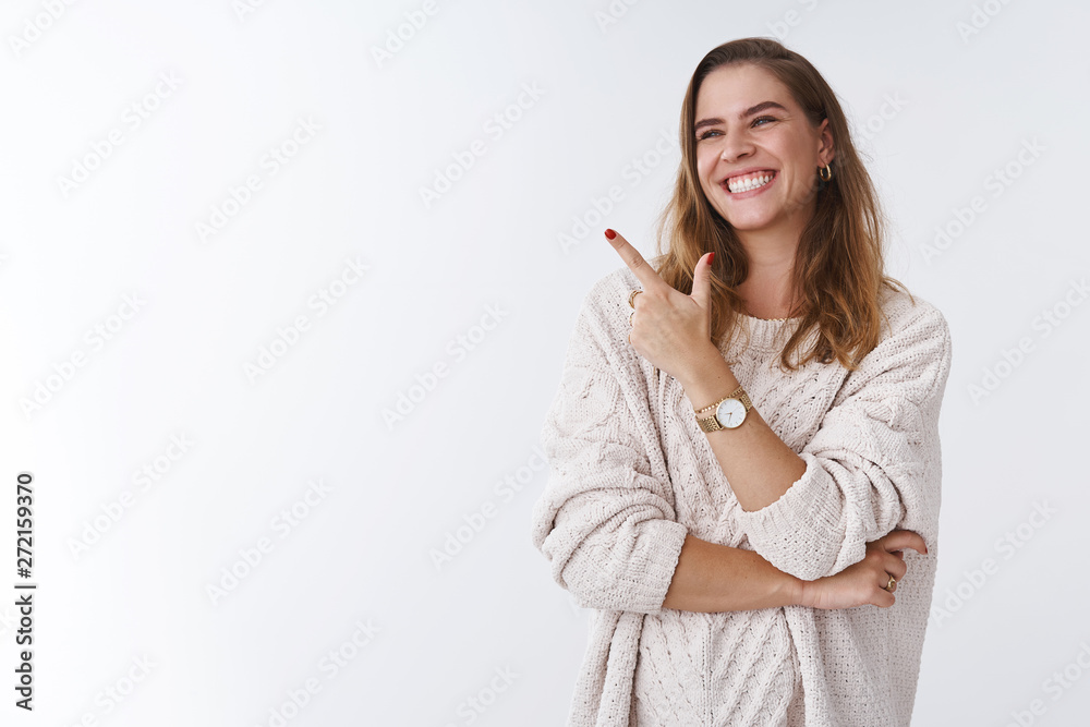 Hilarious scene woman cannot stop laugh. Carefree attractive joyful charming girl turning sideways pointing left corner smiling amused having fun watching funny tv series, standing white background