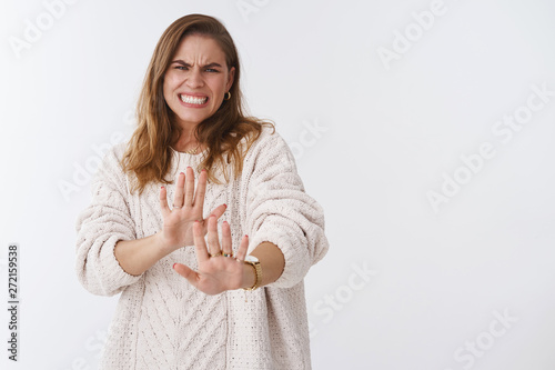 Geez no gross. Disgusted displeased freak out woman step back grimacing aversion disilike raising palms defensive rejecting awful bad offer refusing reluctant bothered, standing white background