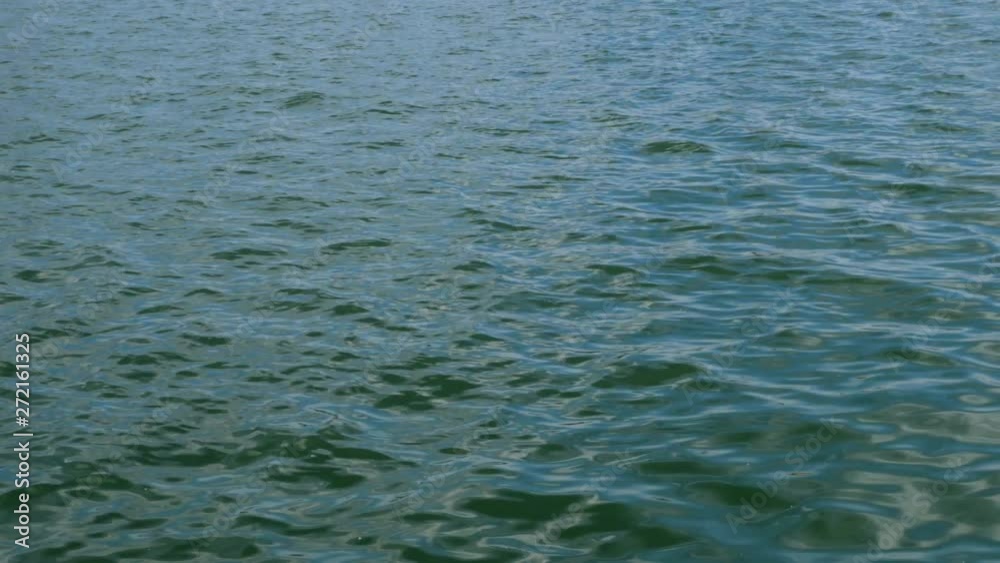 Calm sea wave with ripples running in Black sea. Sun reflection. Natural marine background. Close-up. Calm sea wave with ripples running in Black sea. Sun reflection. Natural marine background. Close-up.