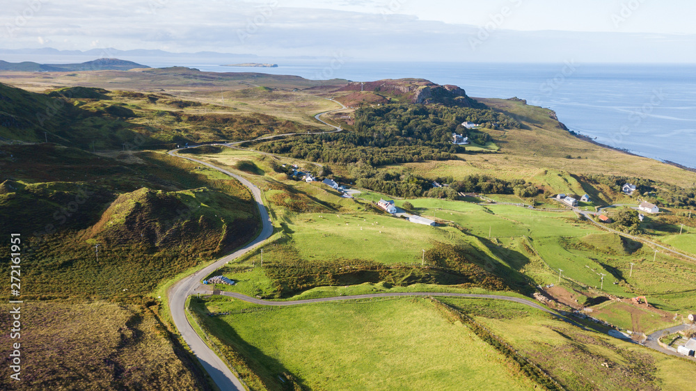 Aerial view of a road crossing through the wilderness of Scottish highlands.