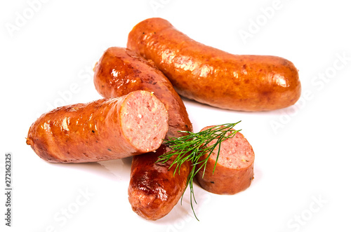 Grilled dill sausages on a light background.Fried pork sausages with greens in a pile on a white background.