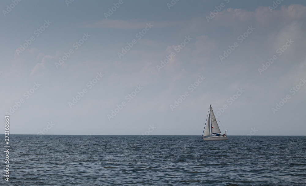 A sailboat in a calm sea on the Mediterranean coast 