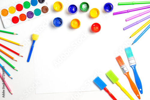 Creative background with art supplies on white background