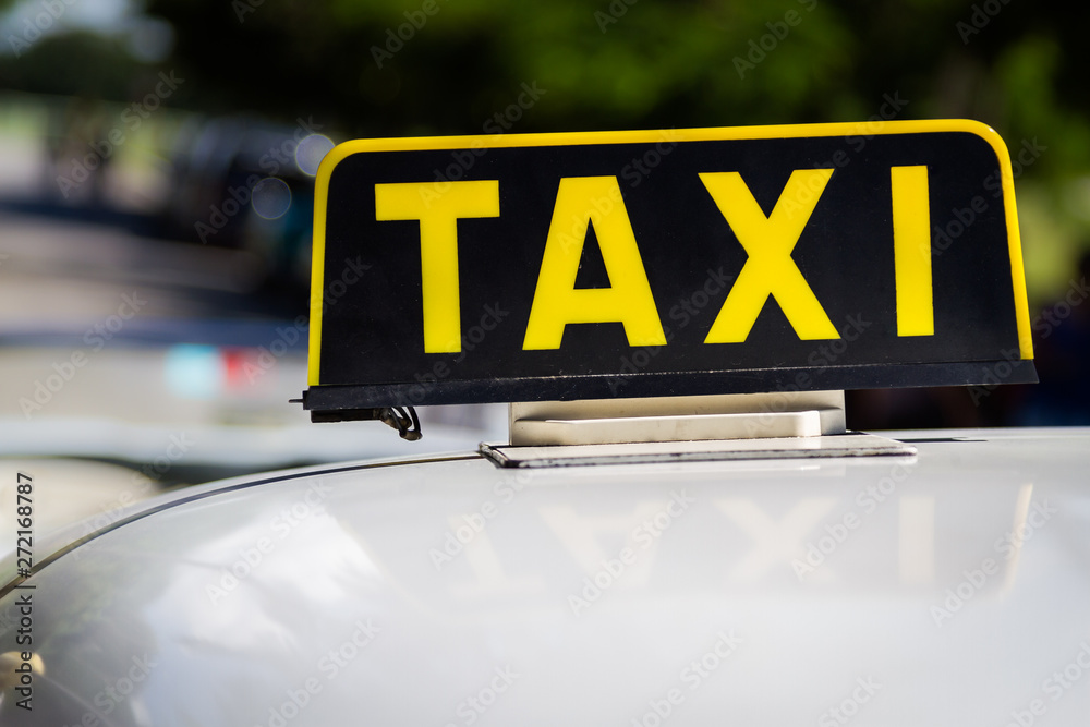 Vintage Taxi sign close up on top of a classic car
