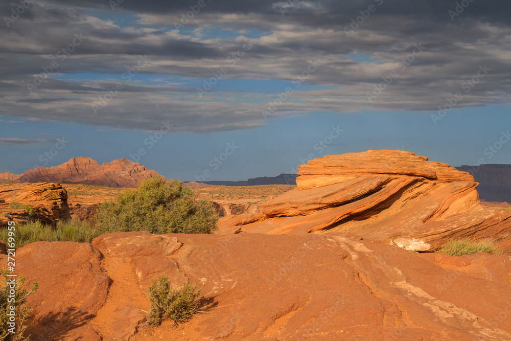 Fototapeta premium Towards Horseshoe bend view with colorful rocks, skies and distance