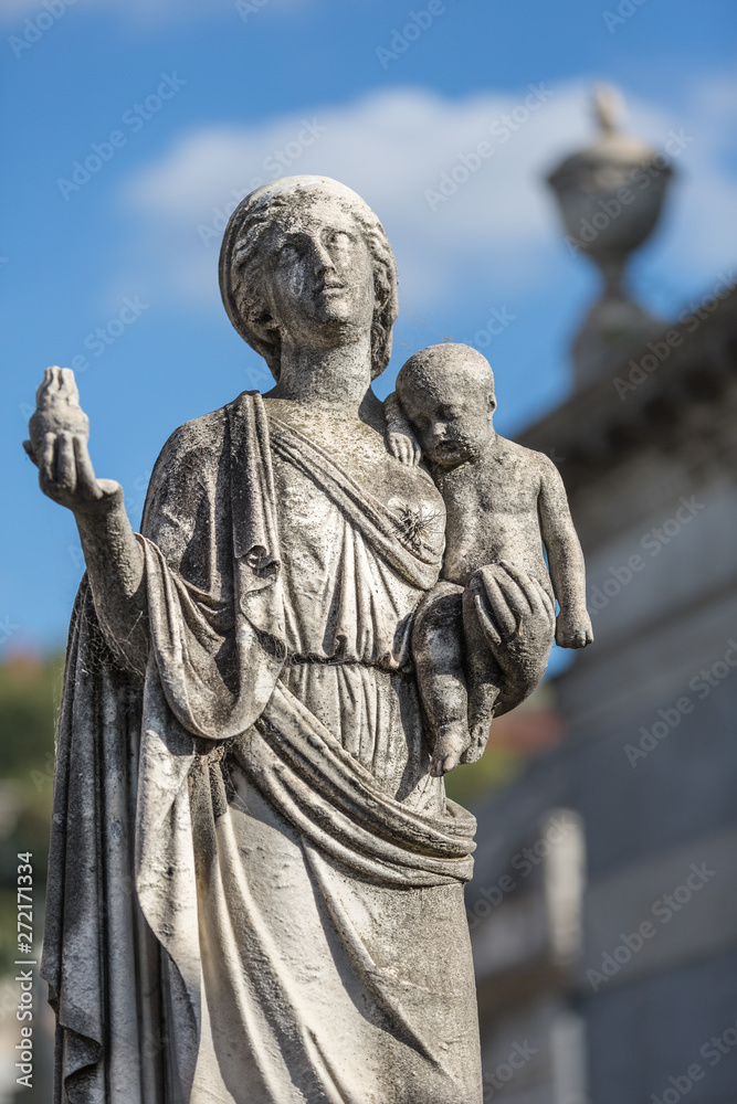 Statue of lady with baby at cemetery