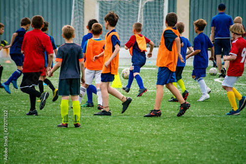 crowd many children kids playing football on the grass field on the stadiums