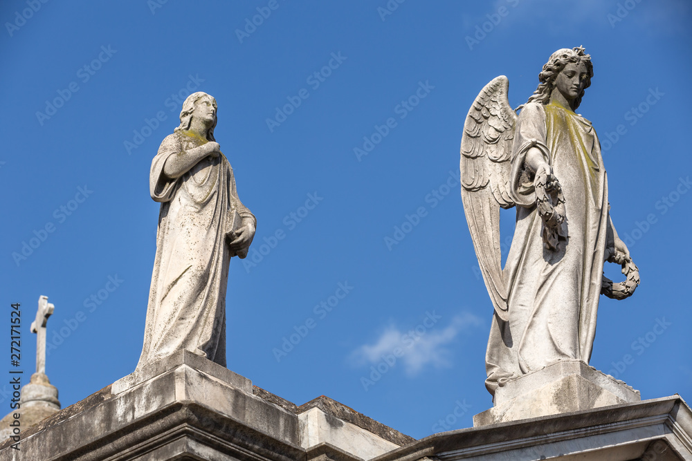 Mausoleum with lady and Angel on top at cemetery