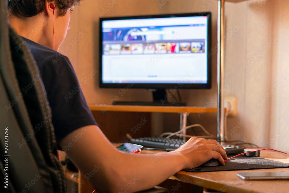 young man working with computer and typing on a keyboard at home, freelancer concepts young man working with computer and typing on a keyboard at home, freelancer concepts