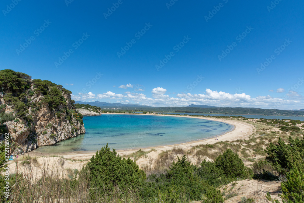 Voidokilia Beach, popular white sand and blue clear water beach in Messinia in Mediterranean area in shape of Greek letter omega, Peloponnese, Greece. Voidokilia Beach, popular white sand and blue clear water beach in Messinia in Mediterranean area in shape of Greek letter omega, Peloponnese, Greece.