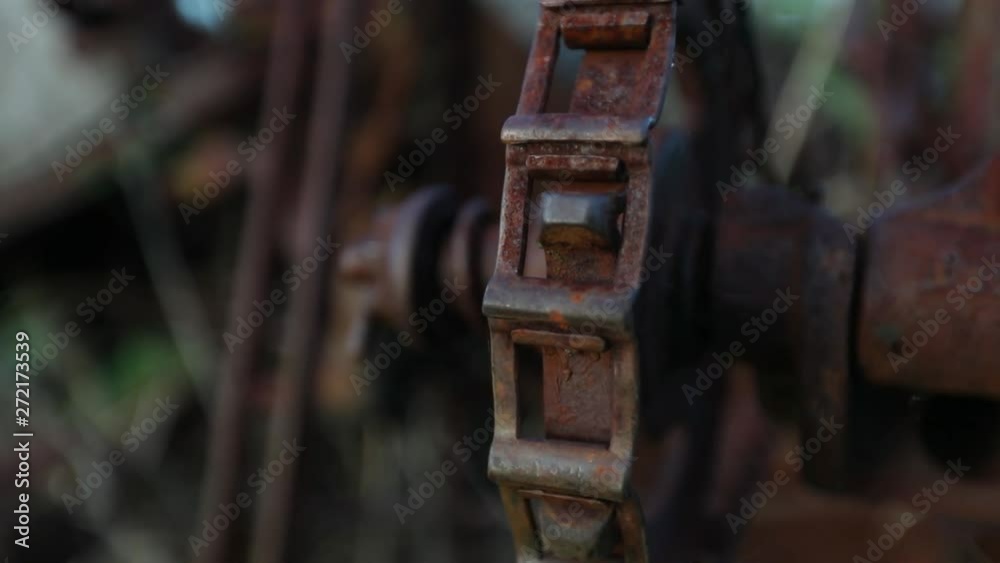 DOLLY OUT SHALLOW DOF Rusty chain of abandoned farm equipment DOLLY OUT SHALLOW DOF Rusty chain of abandoned farm equipment