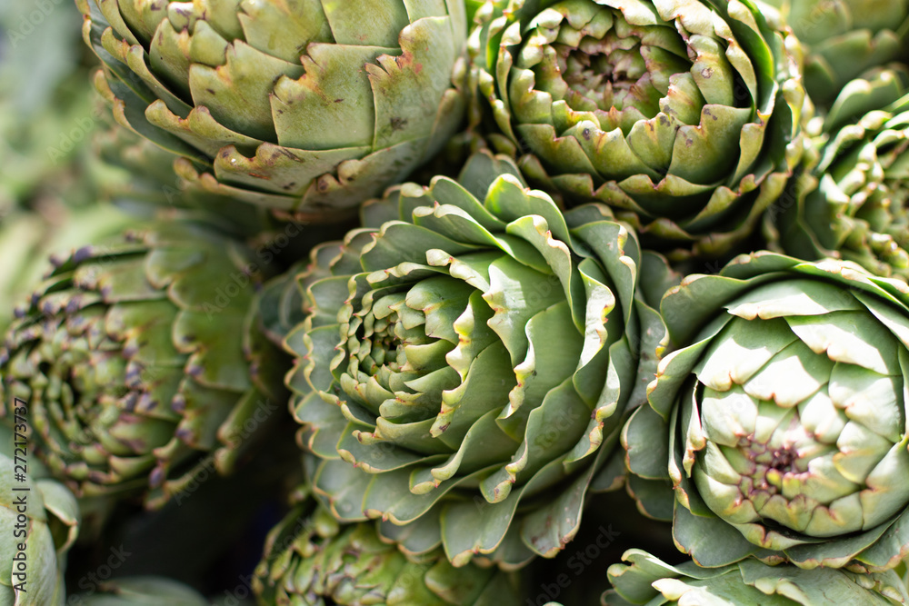 Fototapeta premium Bunch of fresh raw artichokes heads from artichoke plantation in Argolida, Greece on argicultural market in Nafplio