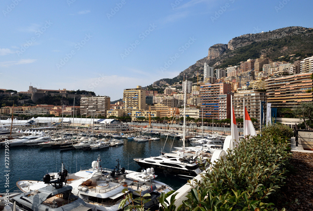 Yachts in bay near houses and hotels, Fontvielle, Monte-Carlo, Monaco, Cote d'Azur, French Riviera. Yachts in bay near houses and hotels, Fontvielle, Monte-Carlo, Monaco, Cote d'Azur, French Riviera.