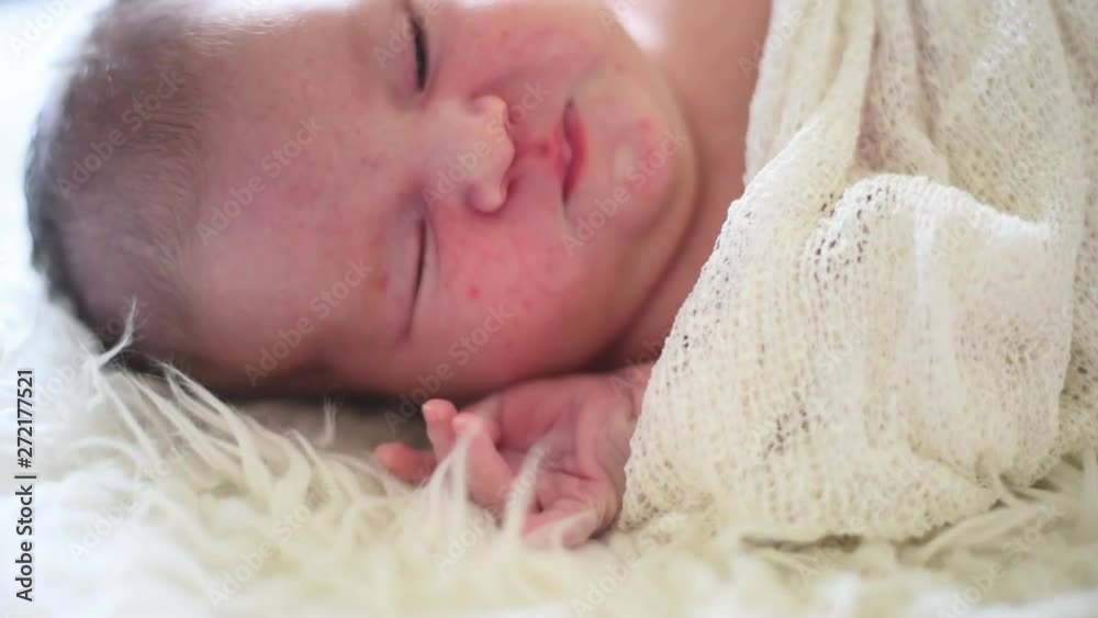 a newborn baby girl is sleeping a newborn baby girl is sleeping