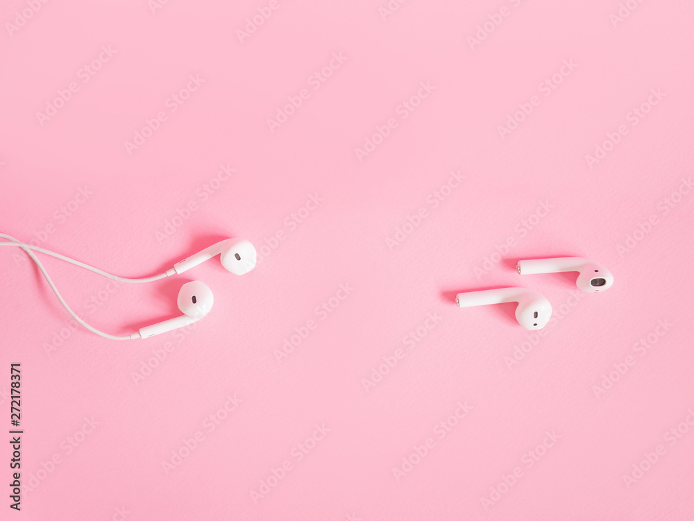 Comparison of two tipes of headphones on pink background. Modern technology pods vs obsolete headphones. Wireless earphones device. New way to leasten music. Concept of free choice. Comparison of two tipes of headphones on pink background. Modern technology pods vs obsolete headphones. Wireless earphones device. New way to leasten music. Concept of free choice.