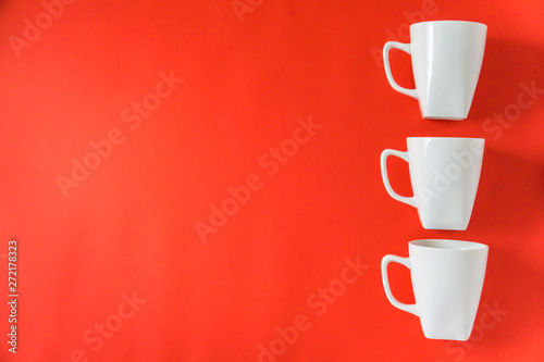 3 winter coffee cup mugs lined up for a break time meeting; Copyspace with empty room space for copy text;