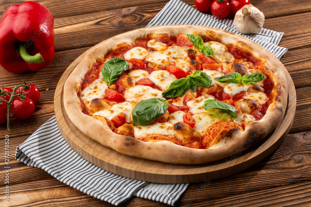 Pizza Margherita on wooden background, top view. Pizza Margarita with Tomatoes, Basil and Mozzarella Cheese close up. 