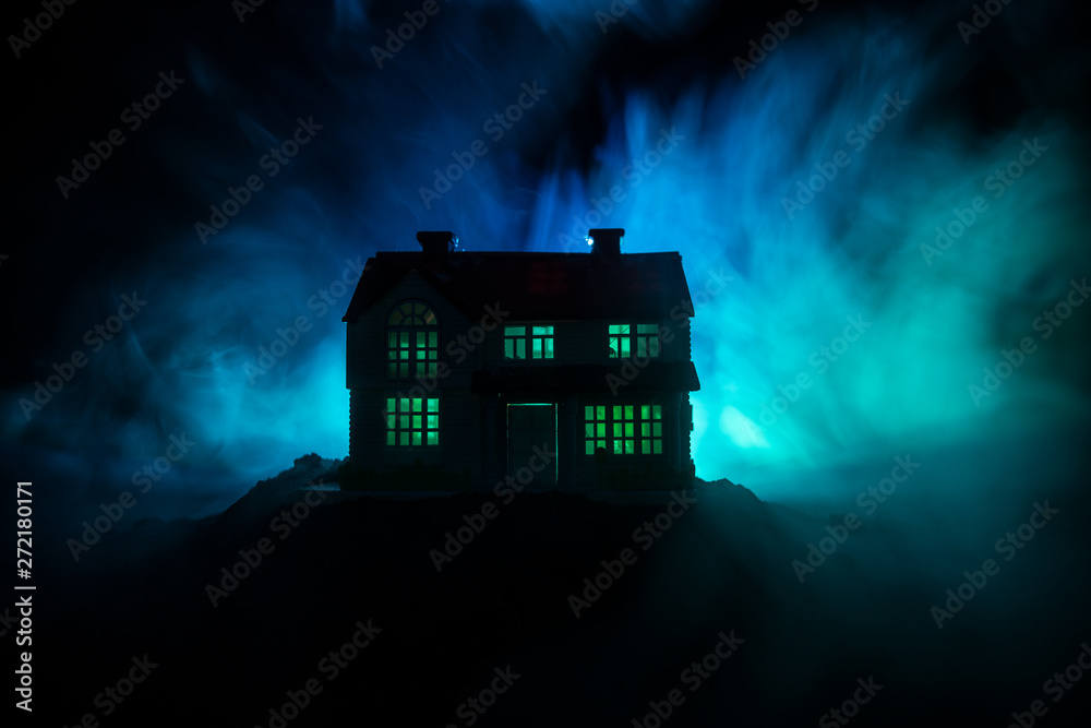 Old house with a Ghost in the forest at night or Abandoned Haunted Horror House in fog. Old mystic building in dead tree forest. Trees at night with moon. Surreal lights. - obrazy, fototapety, plakaty 