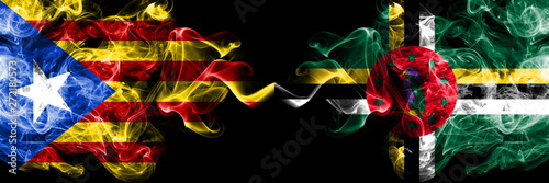 Catalonia vs Dominica smoke flags placed side by side. Thick colored silky smoke flags of Catalonia and Dominica